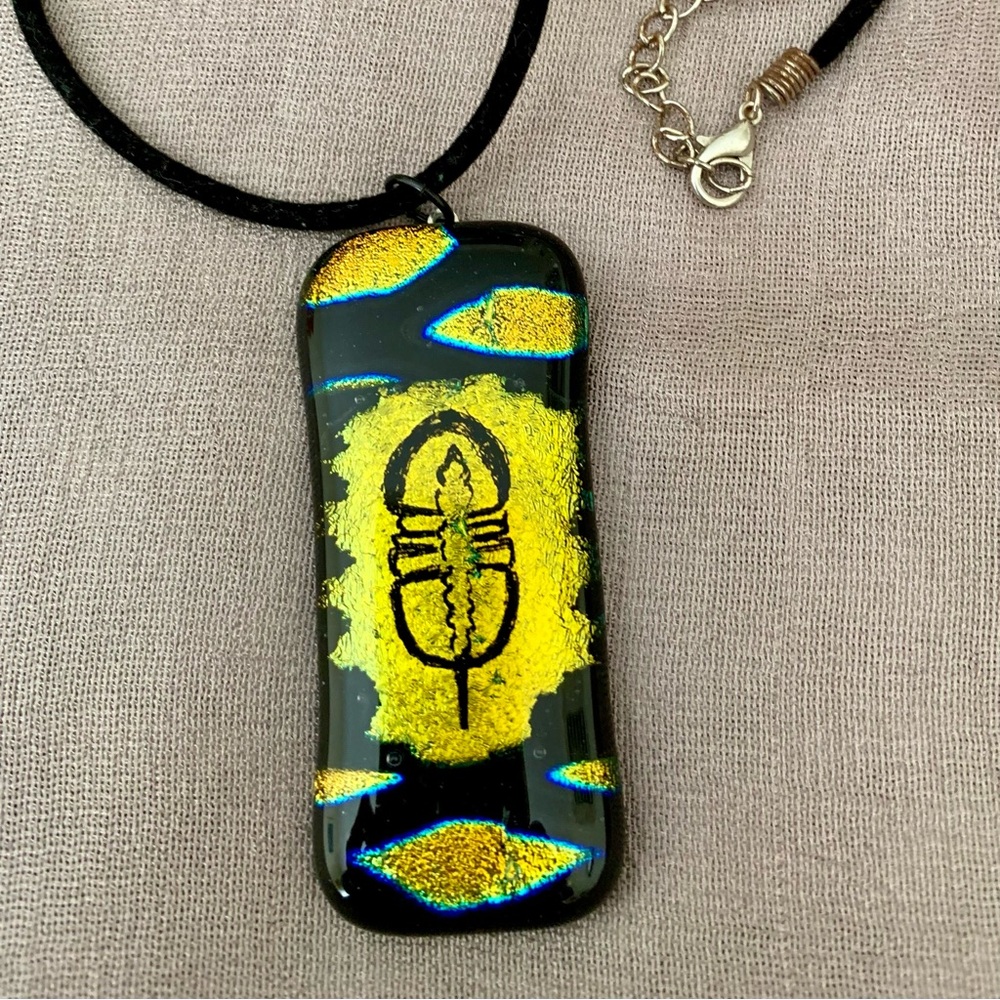 Unique horseshoe crab design dichroic pendant with black cord